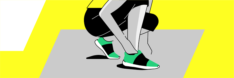 Someone tying their shoes, in workout clothes getting ready to go work out